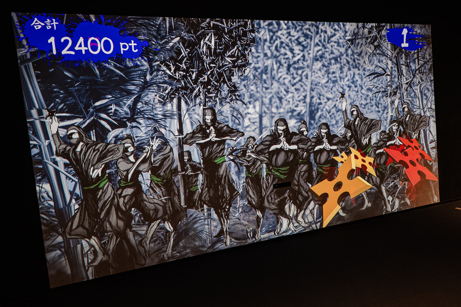 Interactive ninja game screen where visitors throw virtual shuriken at enemies