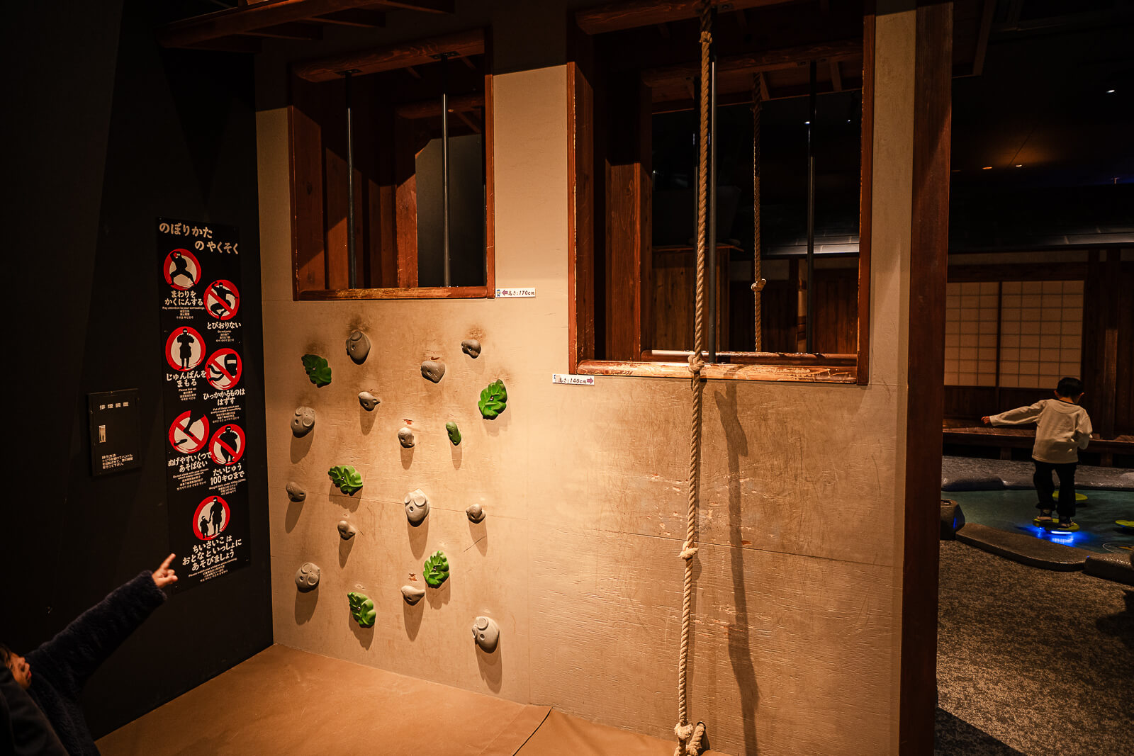 Children climbing and balancing on ninja training wall inside Odawara Castle Ninja Museum