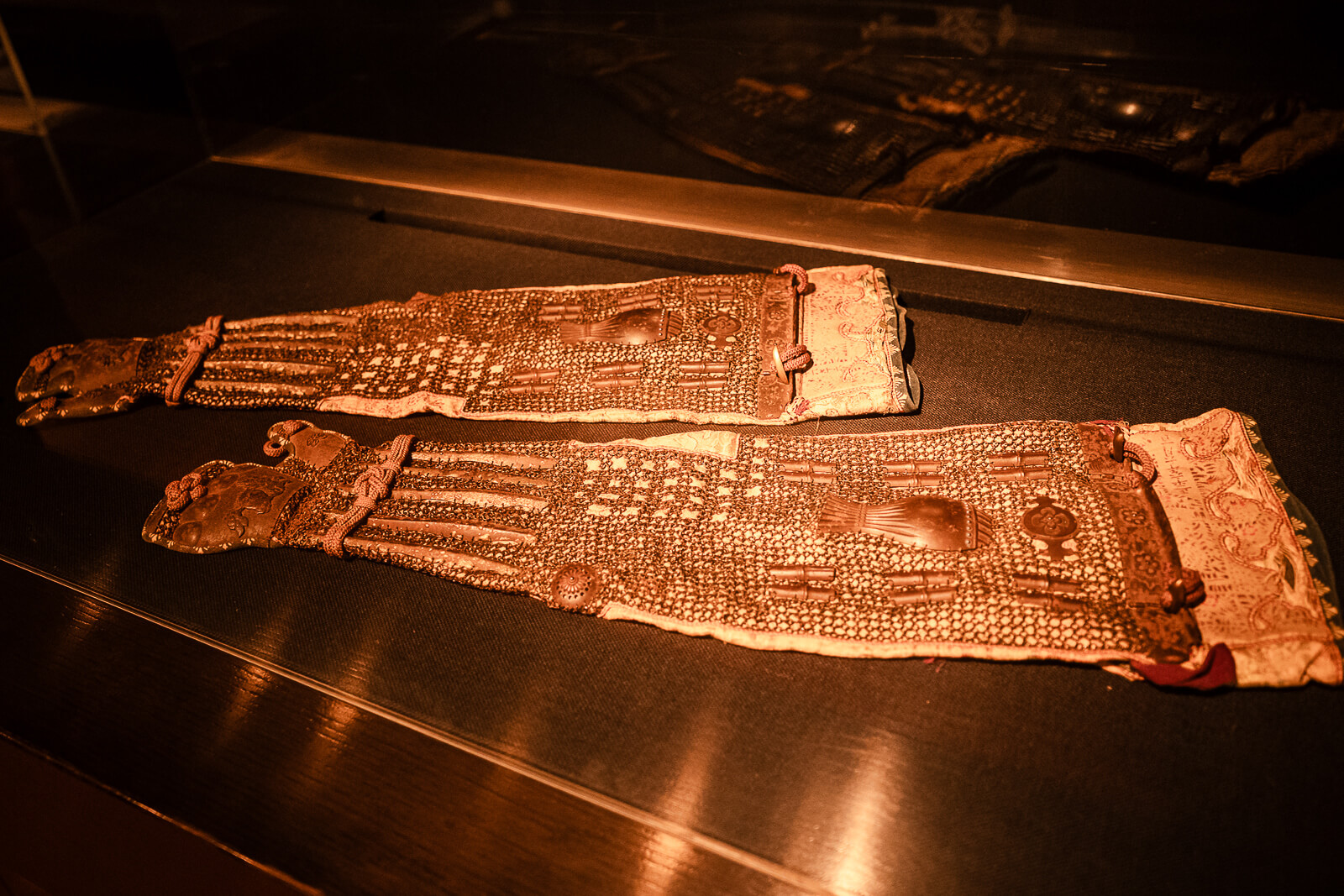 Samurai armor garment laid flat inside display case at Odawara Castle Samurai Museum