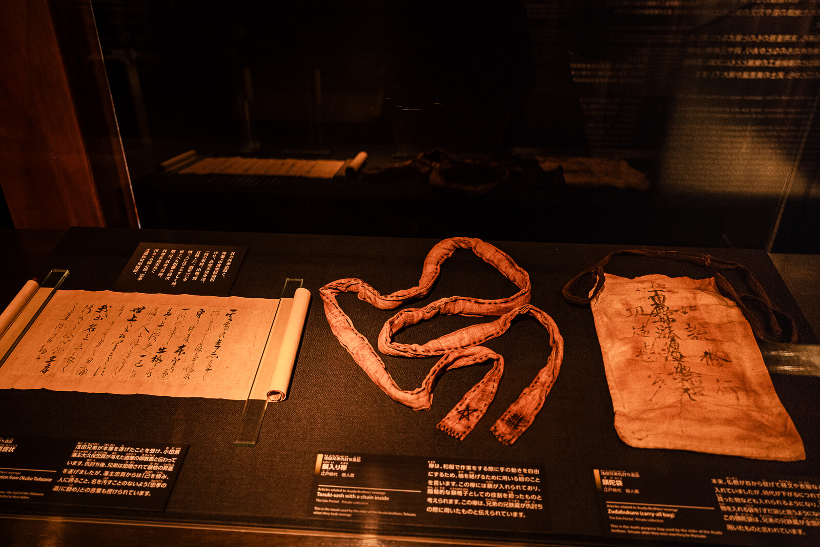 Samurai rope and small artifacts displayed in glass case at Odawara Castle Samurai Museum