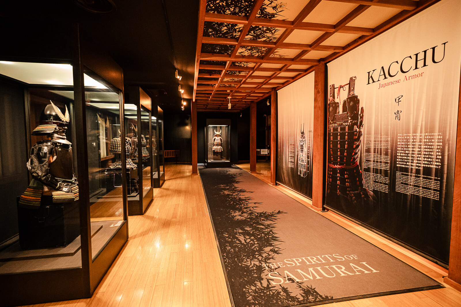 Long corridor with armor exhibits and KACCHU panel inside Odawara Castle Samurai Museum