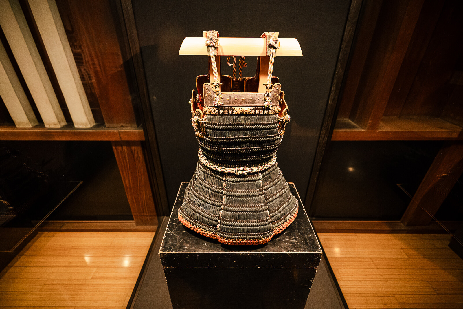 Samurai armor chest piece display on pedestal inside Odawara Castle Samurai Museum