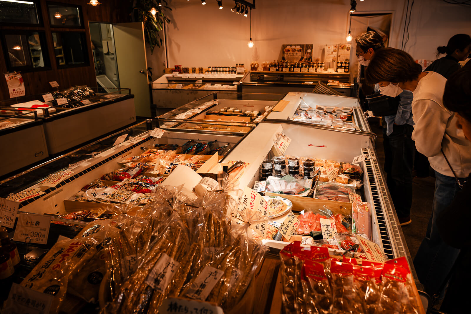 Fresh seafood display counter with packaged fish and prepared items in Odawara