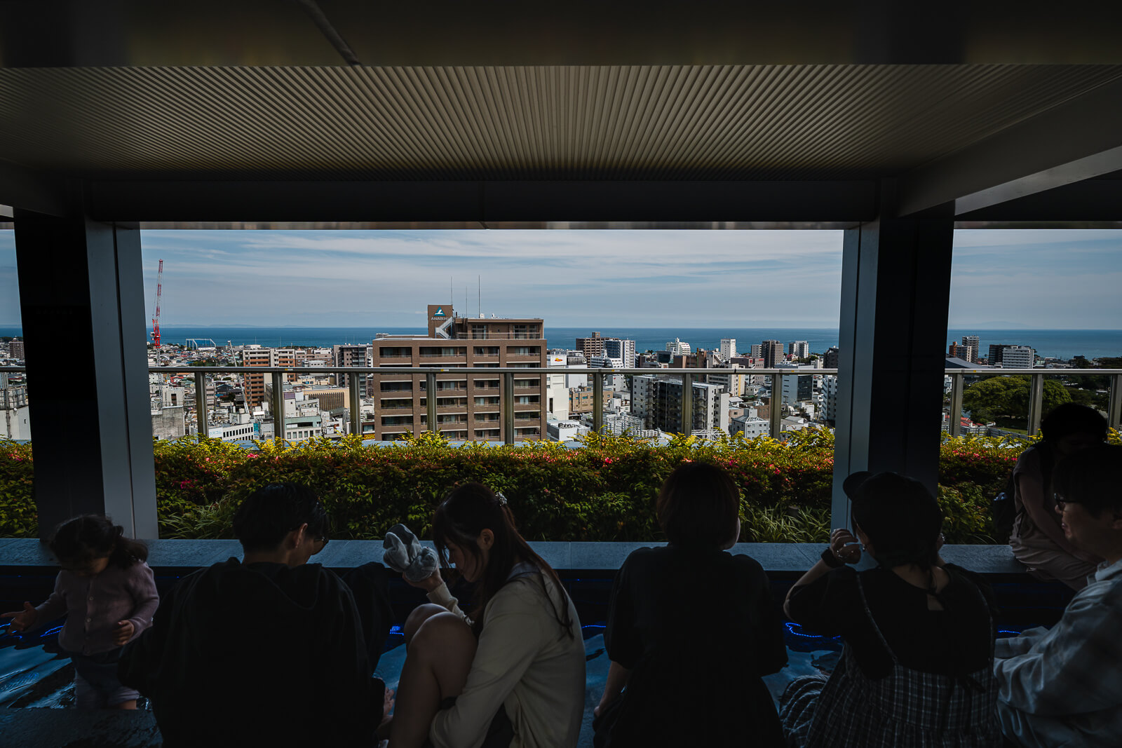 Visitors overlooking Odawara from the upper observation area at Minaka Odawara