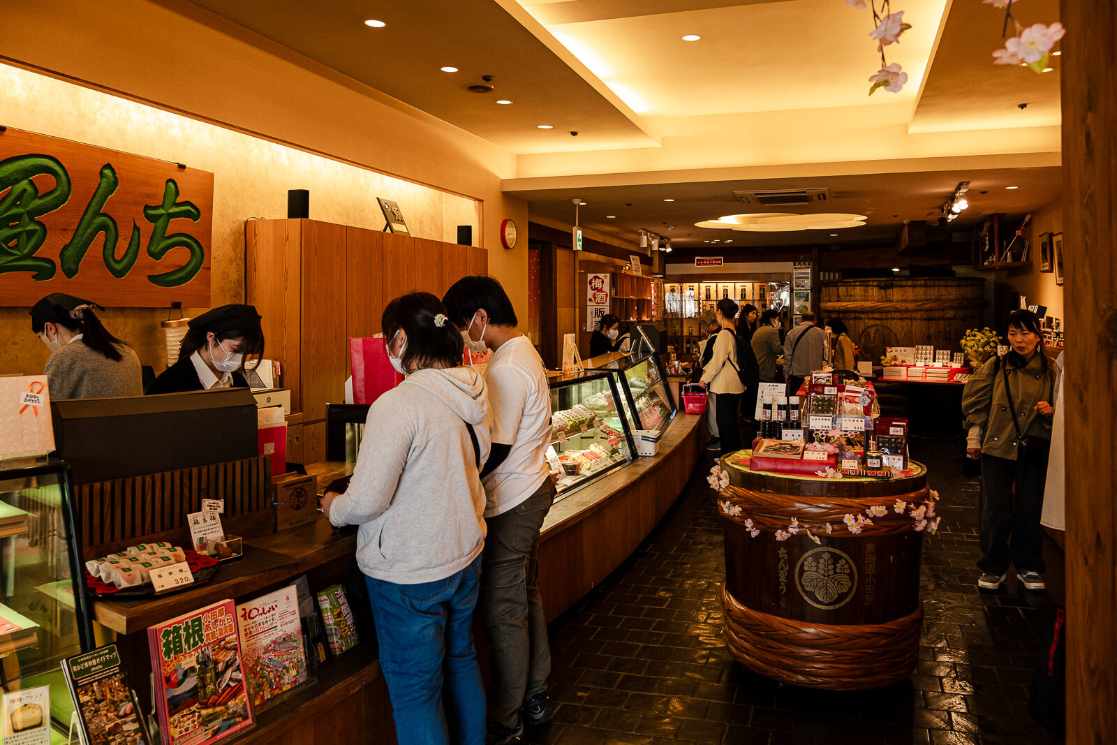 Customers browsing a traditional food and specialty shop on Nishiki Street in Odawara