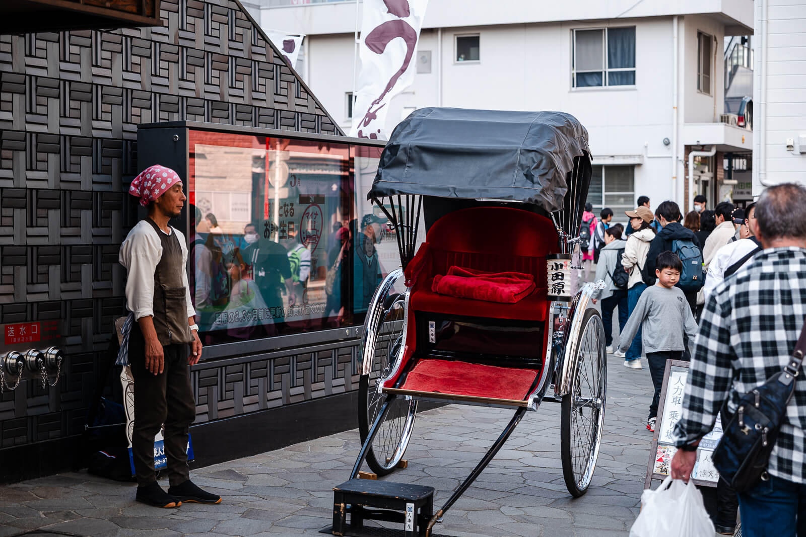 Traditional rickshaw moving through the castle district streets near Odawara Station