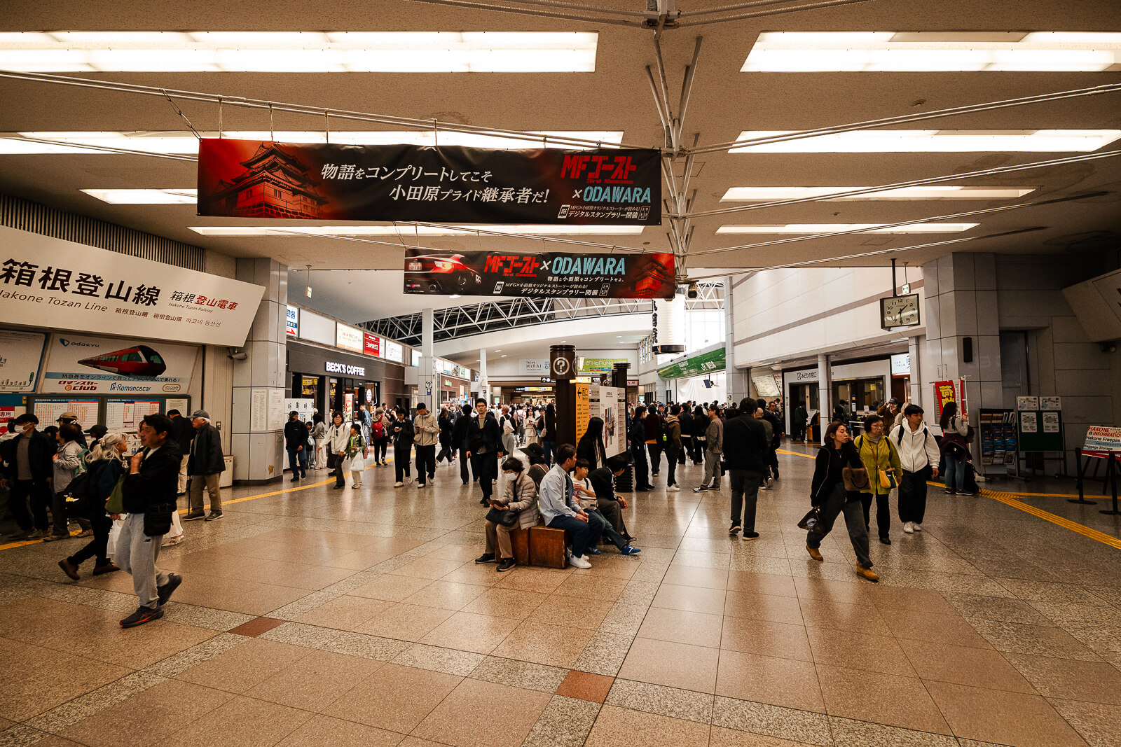 Travelers moving through the main concourse inside Odawara Station in Kanagawa Prefecture, a major gateway connecting Hakone, Atami, and western Japan
