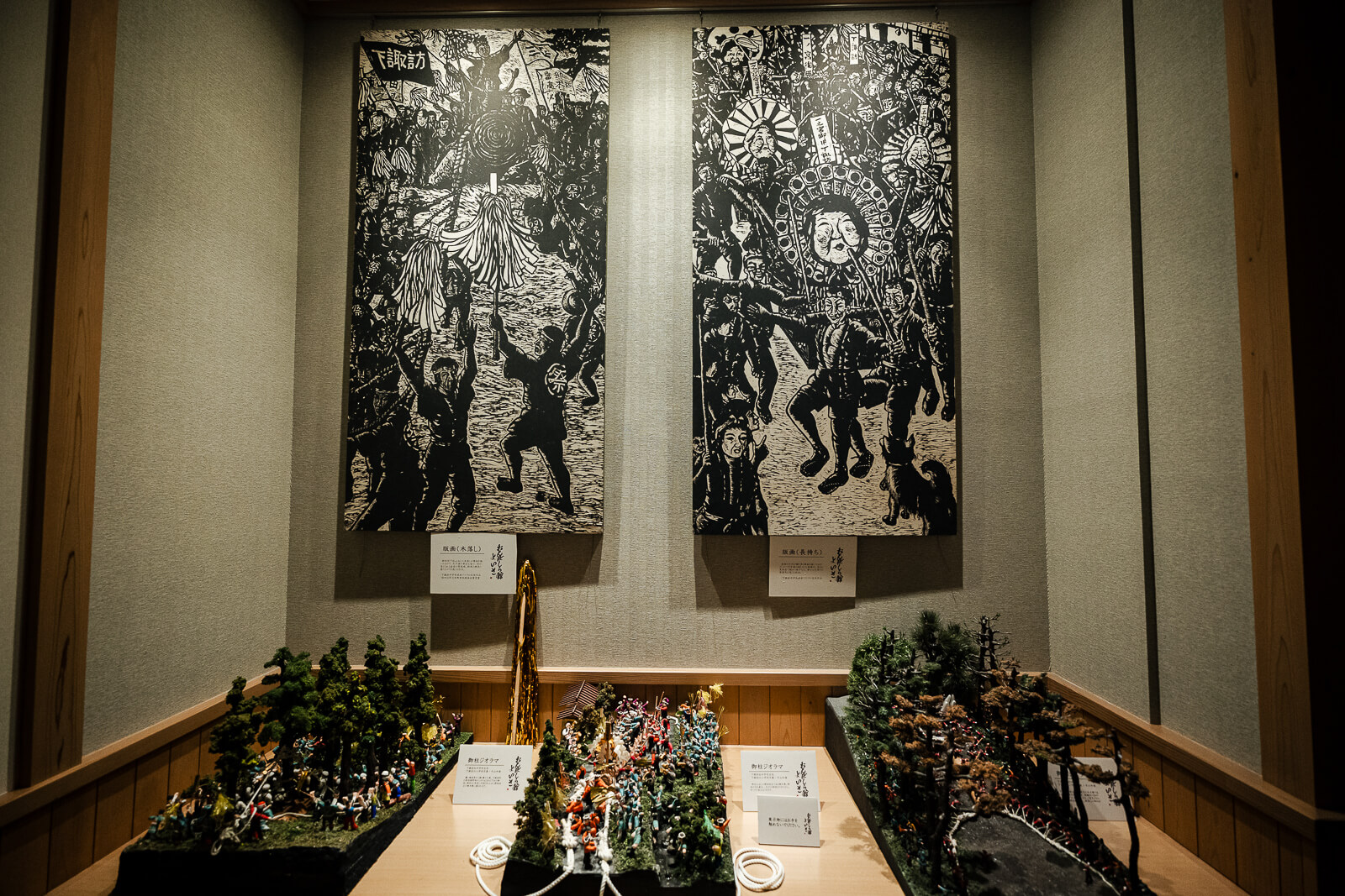 Historical black-and-white Onbashira festival photograph displayed inside the museum.