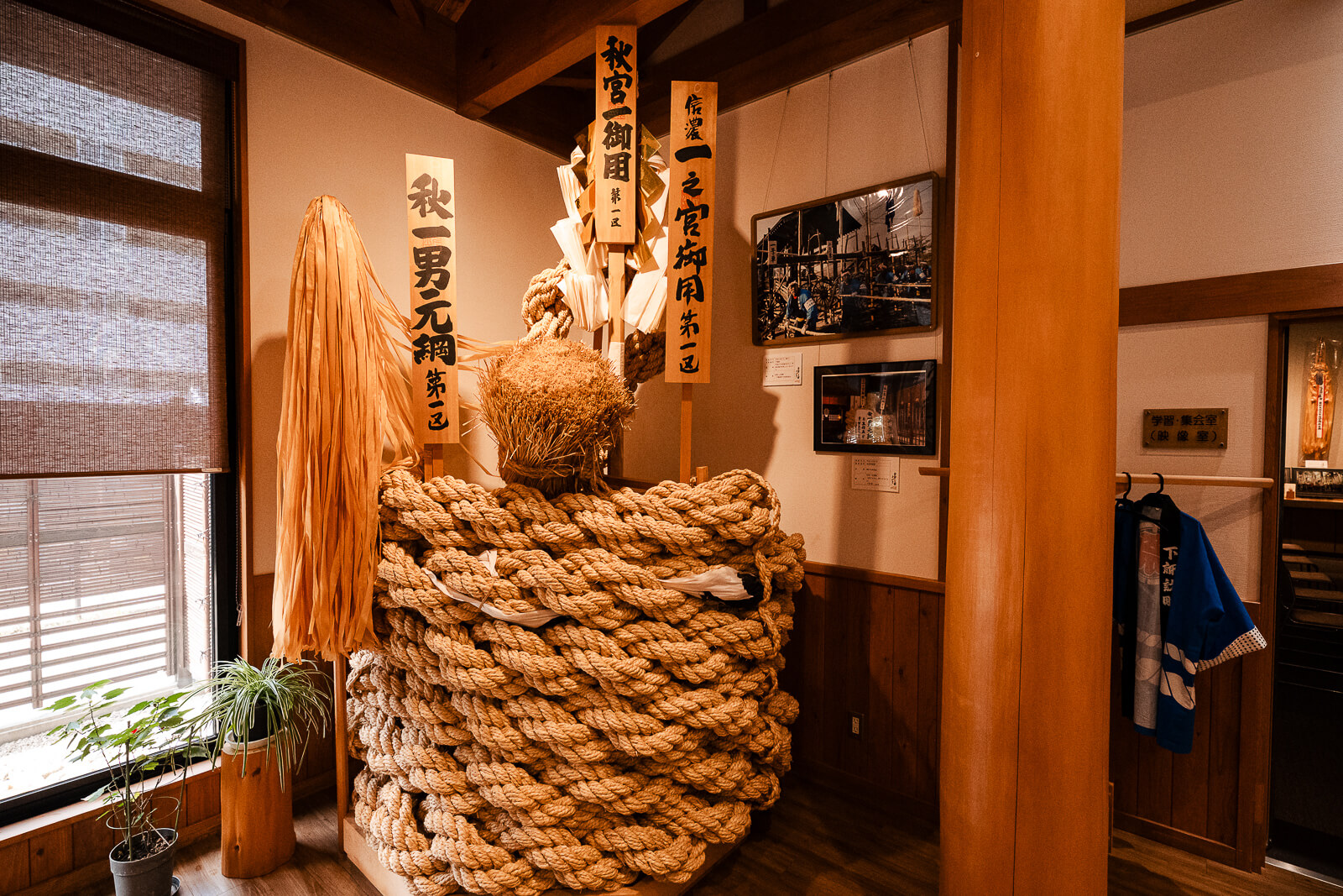 Large ceremonial rope display inside the Onbashirakan Yoisa Museum in Shimosuwa.