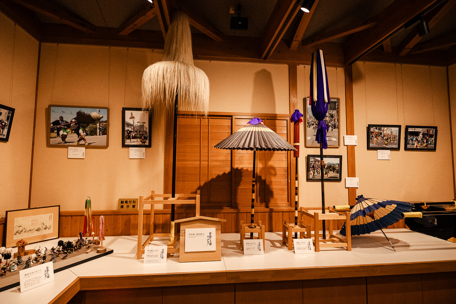 Historical exhibits and photographs inside the Onbashirakan Yoisa Museum in Shimosuwa.