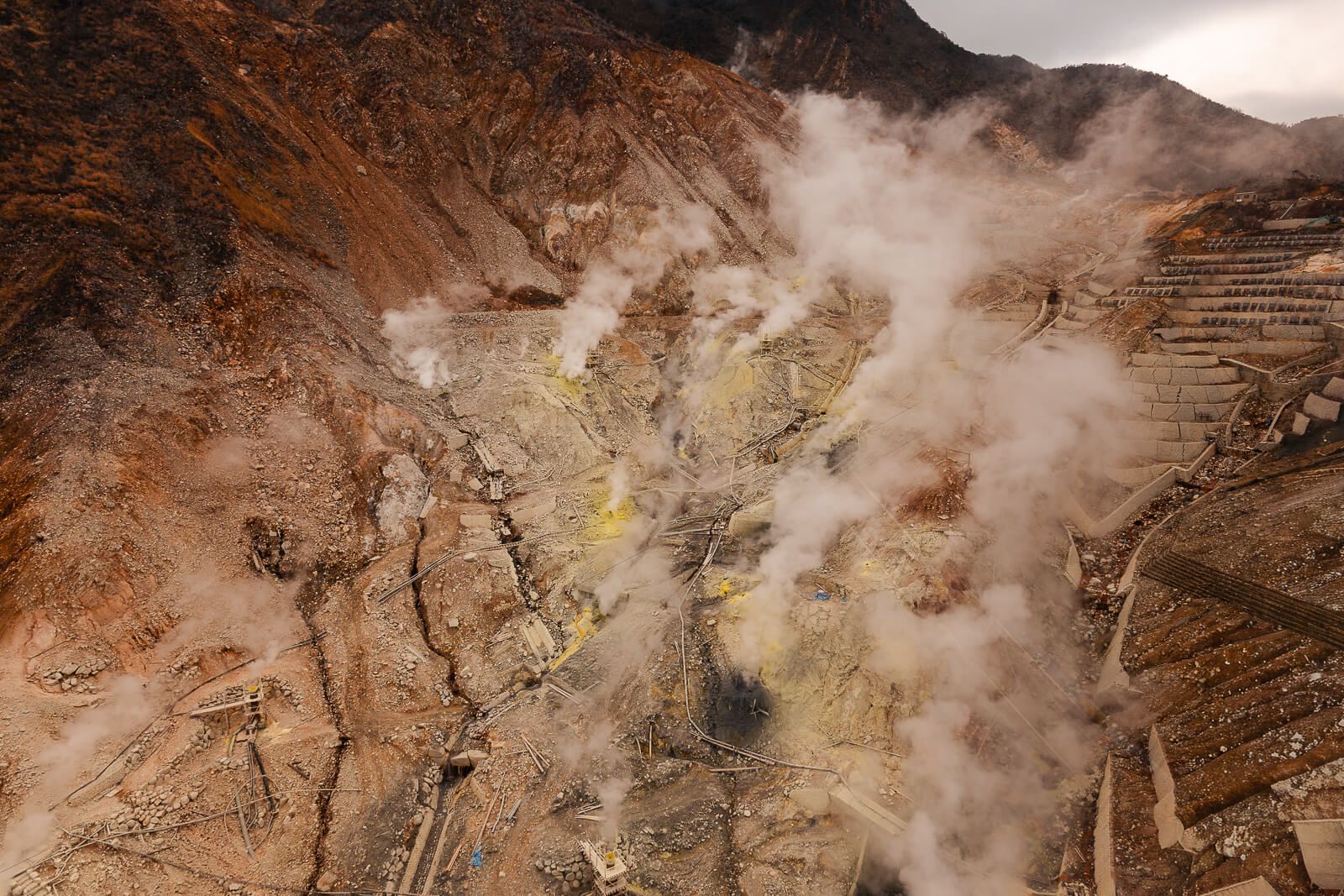 Steam vents seen directly below from the ropeway with rugged volcanic terrain
