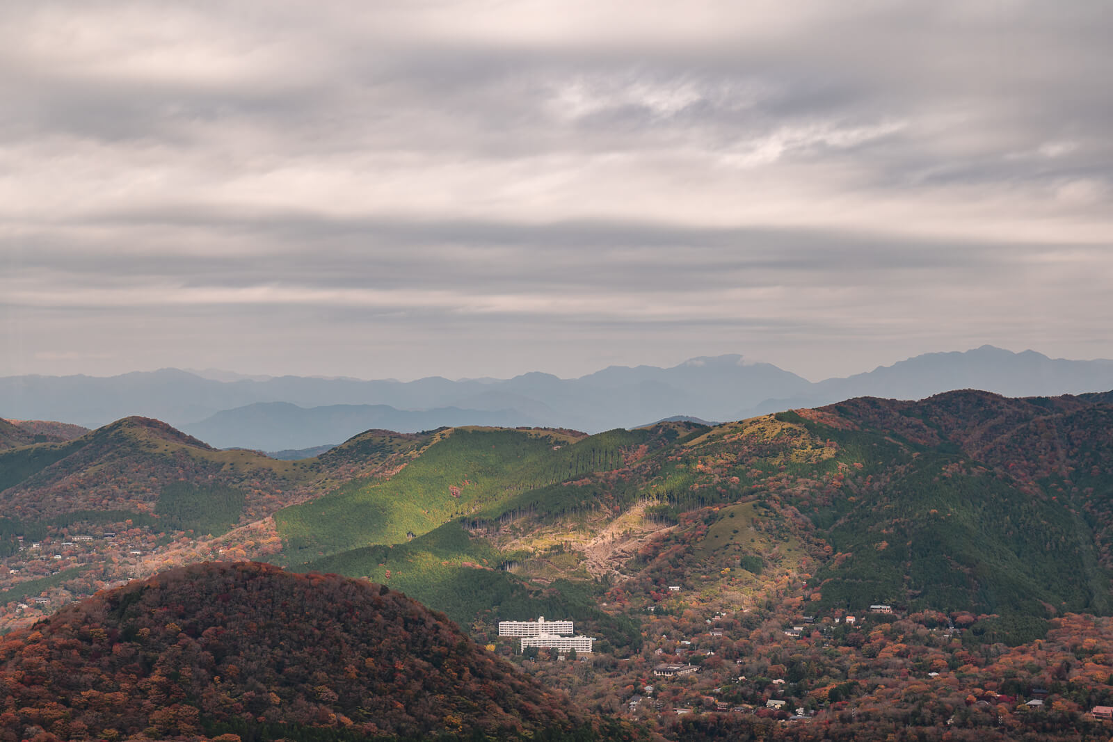 Mountain landscape beyond Owakudani with layered hills and distant ridgelines