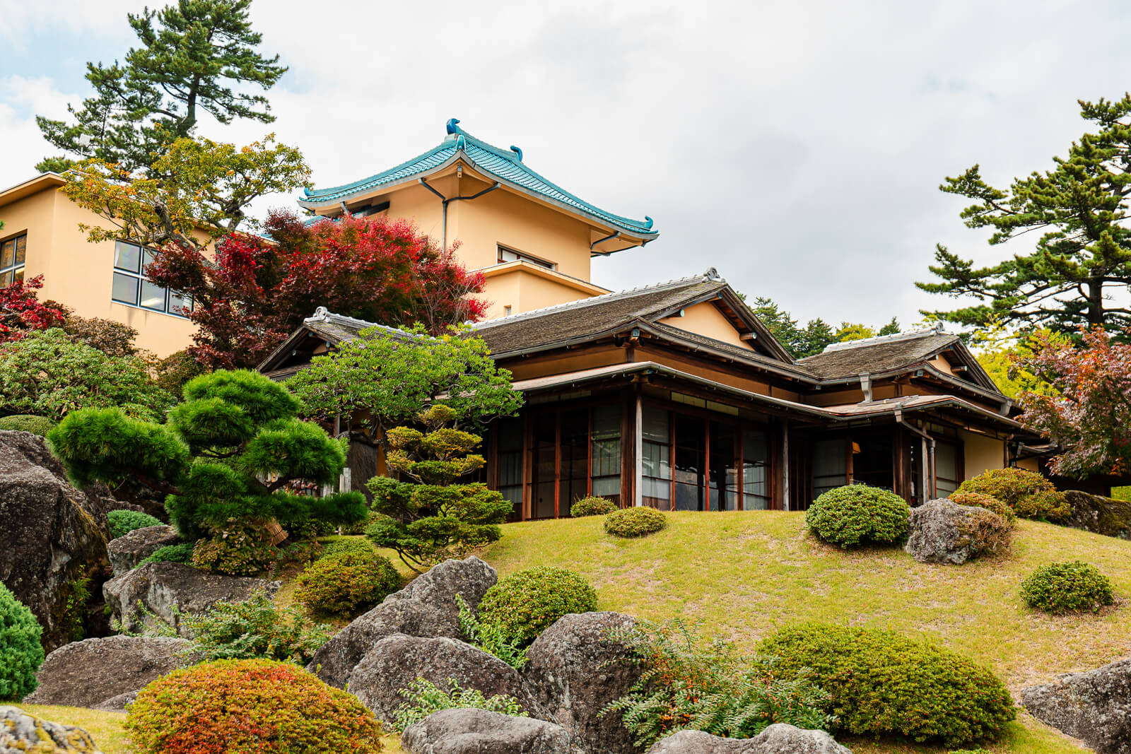 Traditional museum building surrounded by the landscaped grounds of Shinsenkyo Garden in Hakone