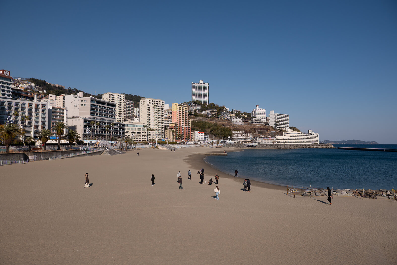 Waterfront buildings and promenade behind Atami Sun Beach near Atami Station