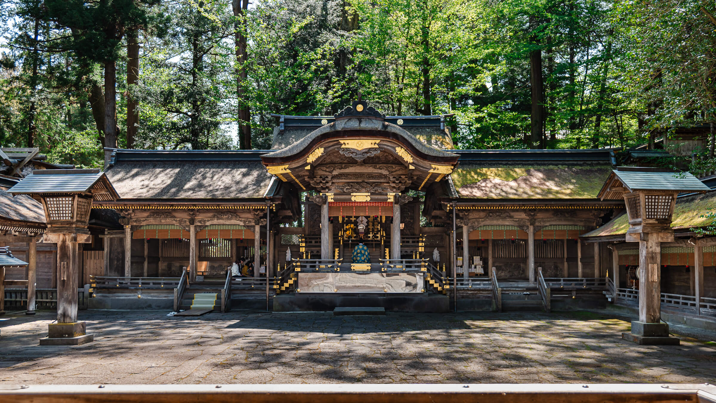 Main shrine hall at Suwa Taisha Kamisha Honmiya surrounded by forest in Nagano