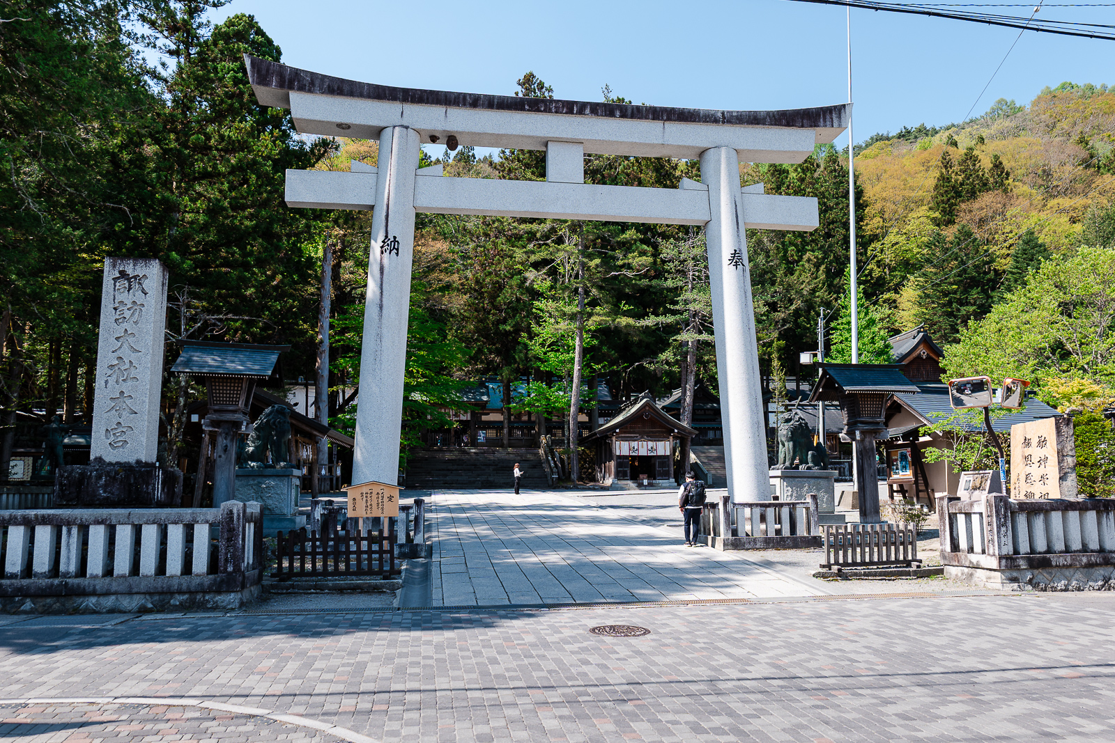 Torii gate framing the mountain-facing axis at Suwa Taisha Kamisha Honmiya, Suwa