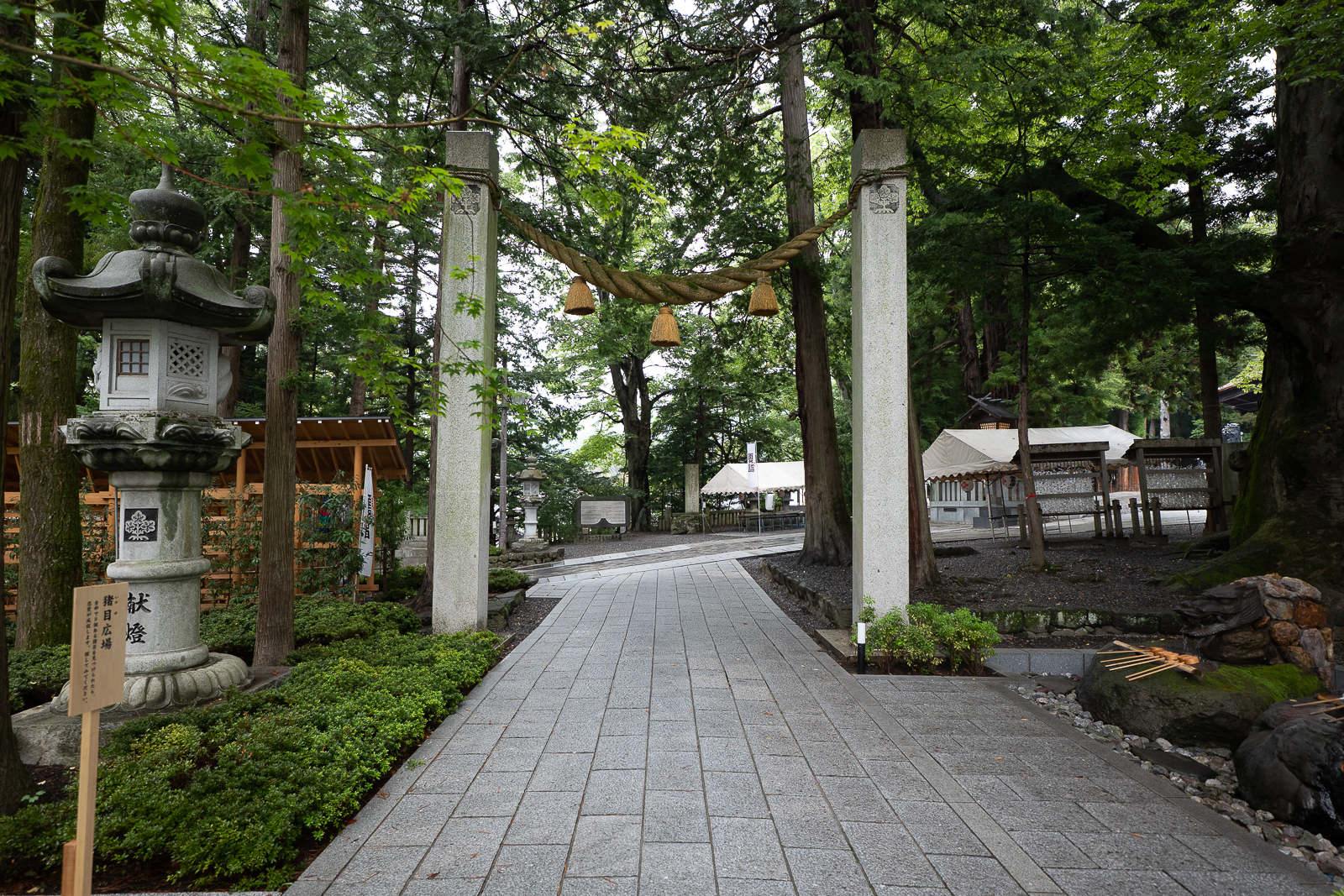 stone lanterns along shrine path at Suwa Taisha Shimosha Akimiya in Shimosuwa Nagano