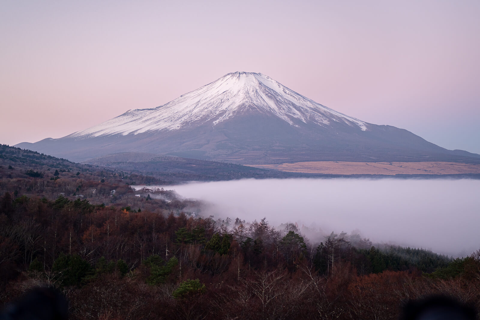 Snowy Fuji before the strong sunrise glow with fog below at Yamanakako Panoramadai